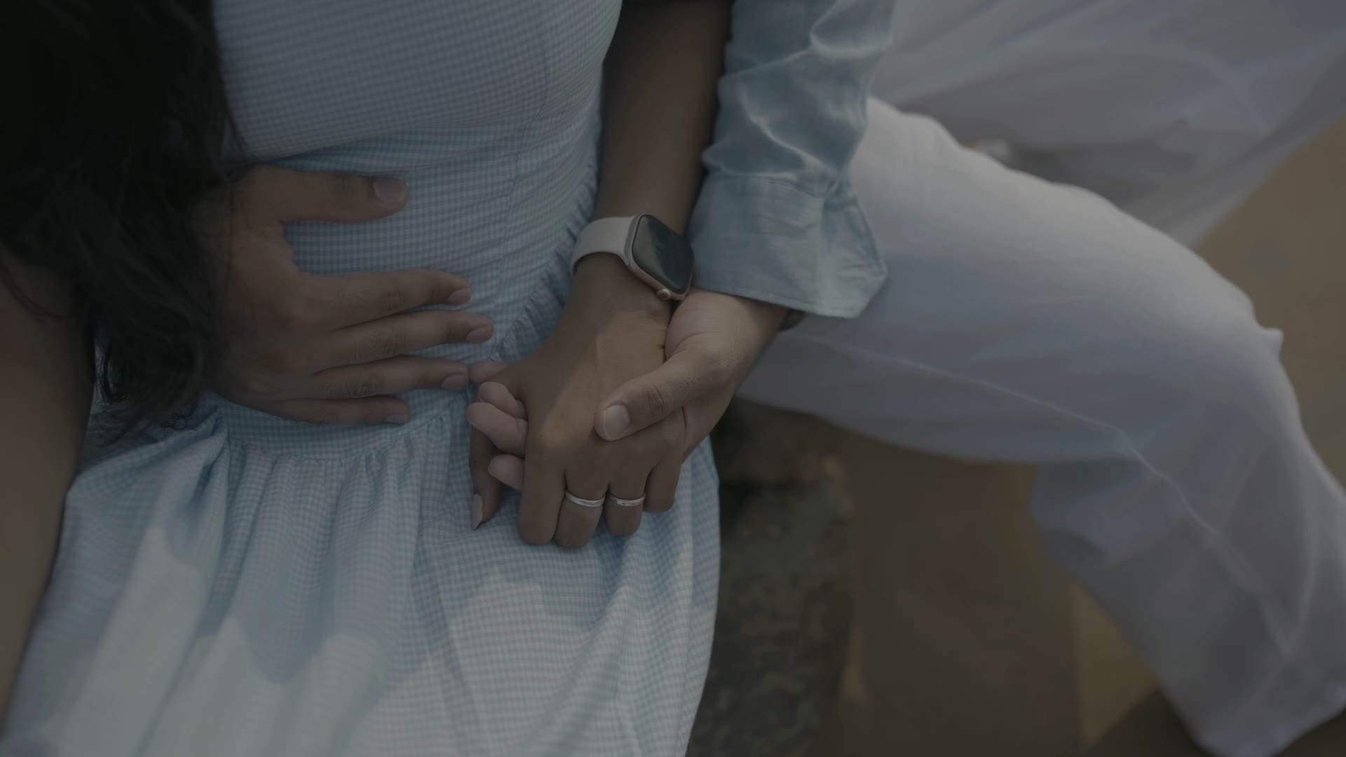 Roshini and Jayanth holding hands, wearing their rings